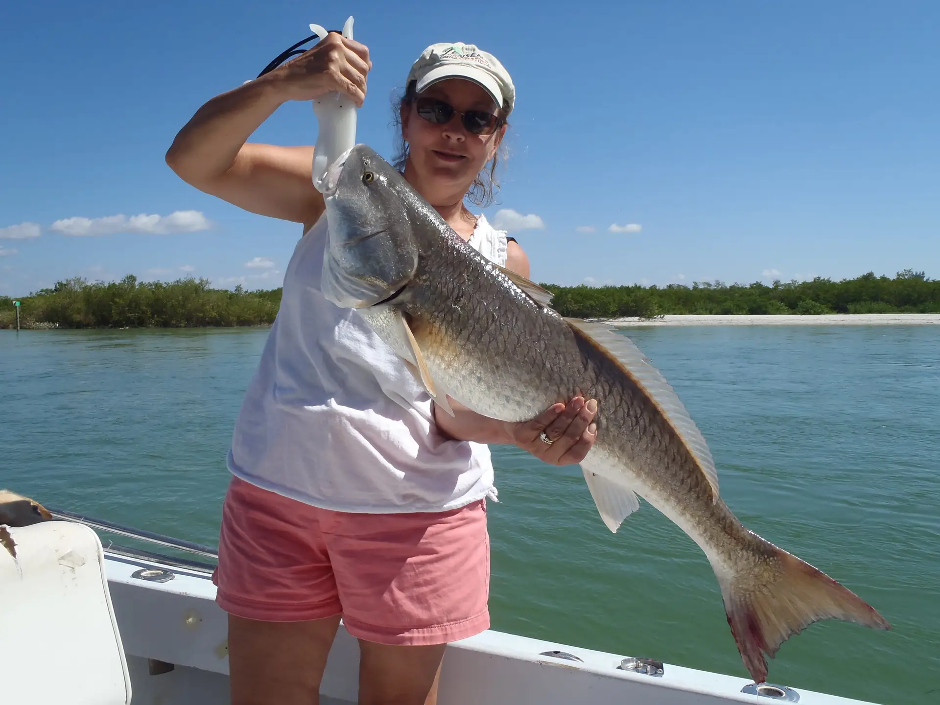 Pam and her huge Redfish caught on Sanibel & Captiva charters!
